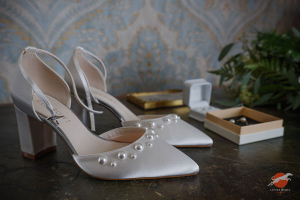 Pearl-detailed bridal shoes displayed with wedding jewellery at Askham Hall
