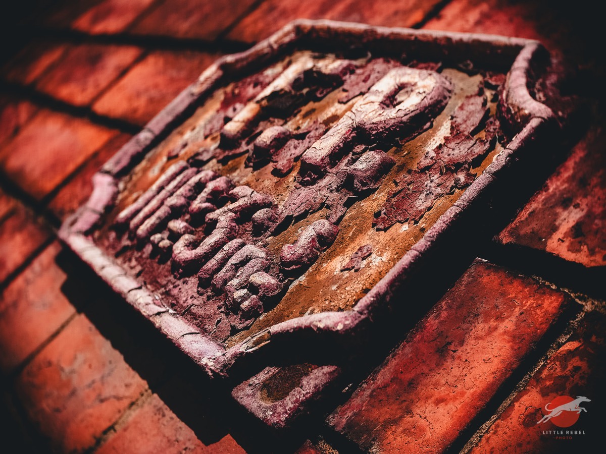Weathered cast-iron fire point sign on the Clothworkers’ Central Building in Leeds