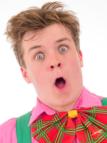 Studio portrait of presenter and entertainer Joey Wilby wearing an oversized tartan bow tie