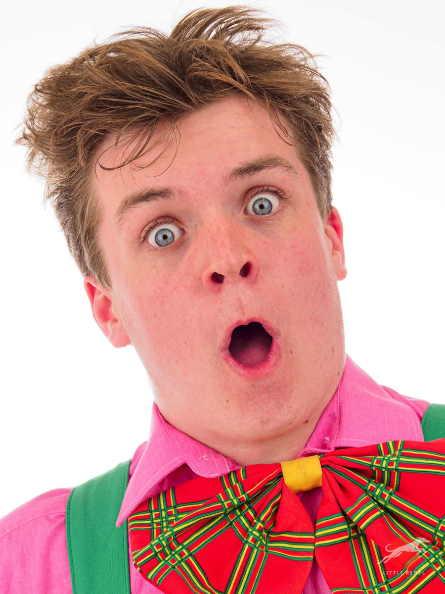 Studio portrait of presenter and entertainer Joey Wilby wearing an oversized tartan bow tie