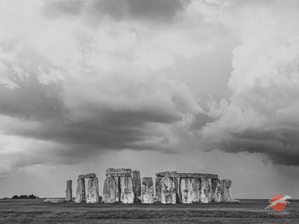 Black-and-white view of Stonehenge beneath dramatic clouds on Salisbury Plain