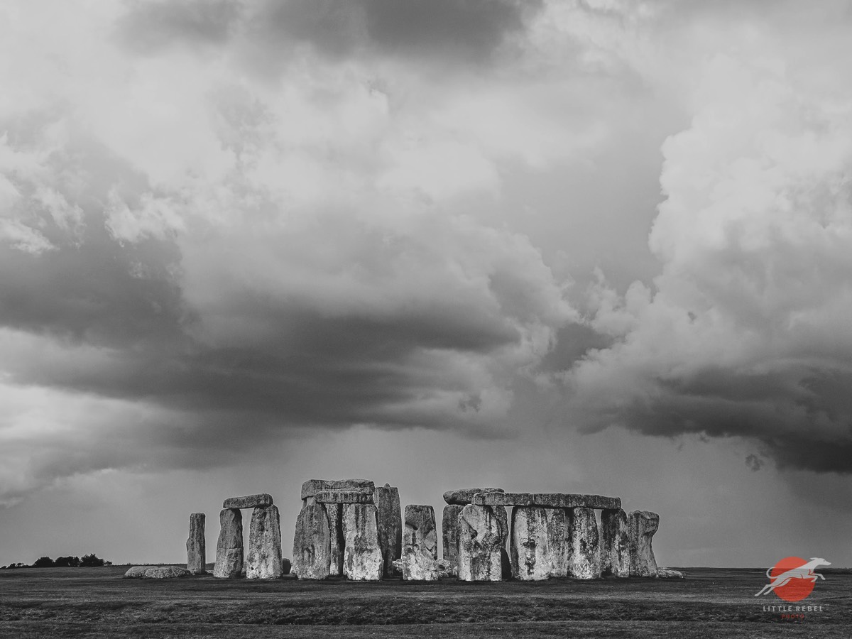 Black-and-white view of Stonehenge beneath dramatic clouds on Salisbury Plain