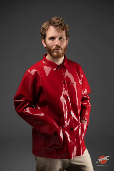 Male model wearing a glossy red rubber chore jacket by Wrapped in Rubber
